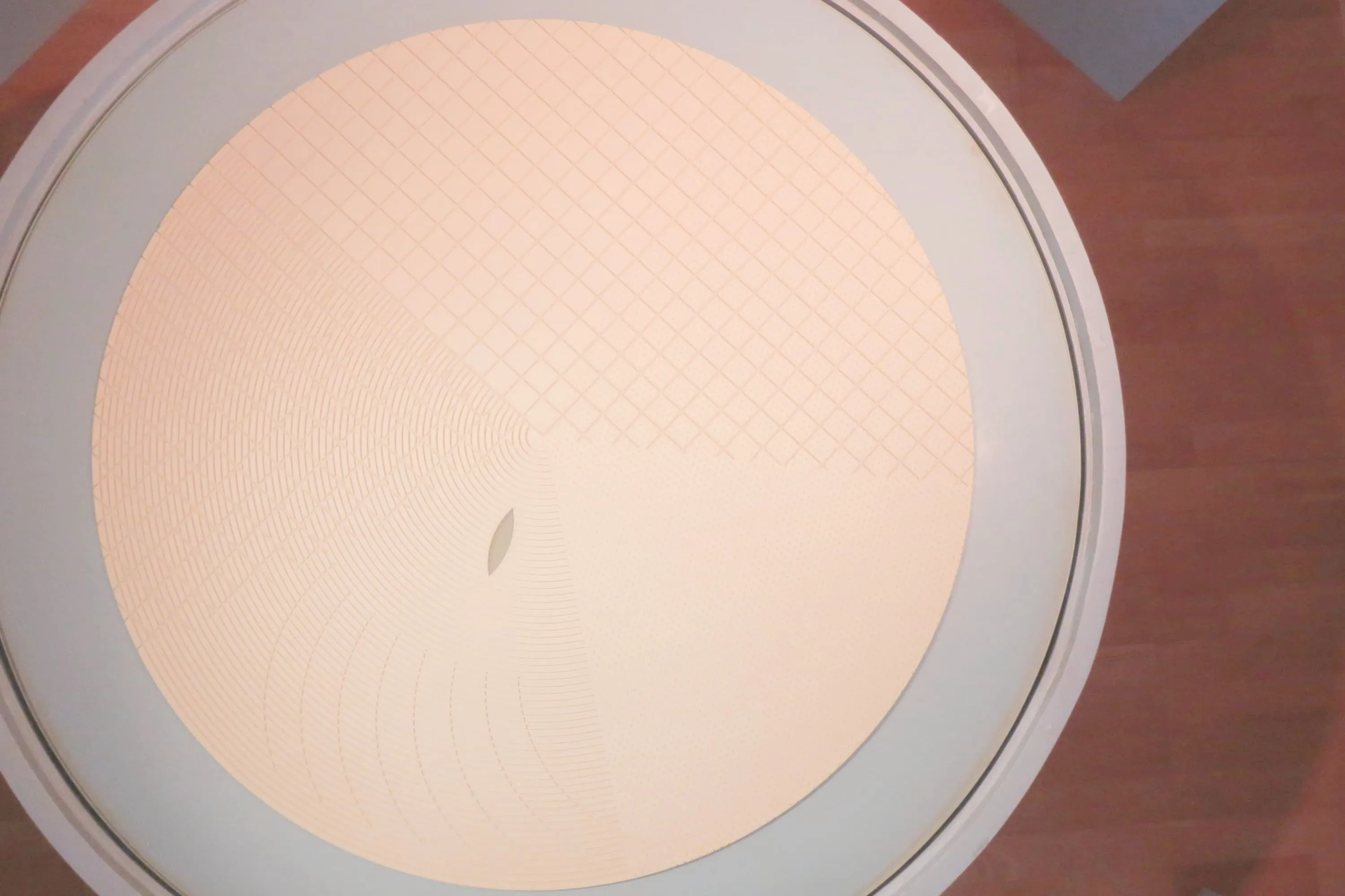 IV Technologies polishing pad with concentric and crosshatched surface grooves.