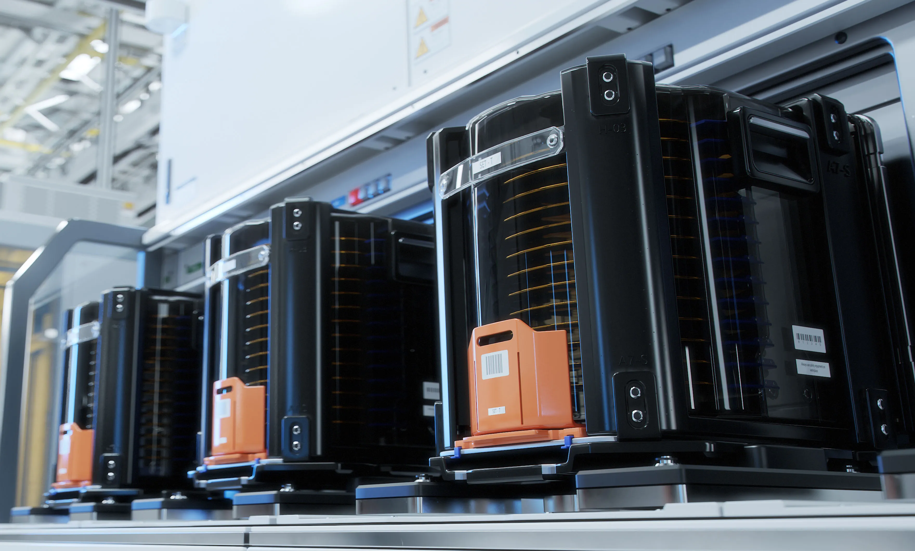 Wafer carriers shown on Nytex’s website, with black containers lined up beside equipment.