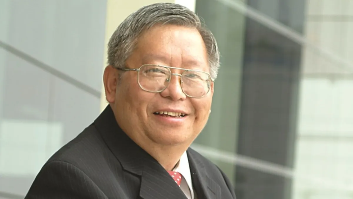 Wei-Jen Lo in a dark suit and red tie.